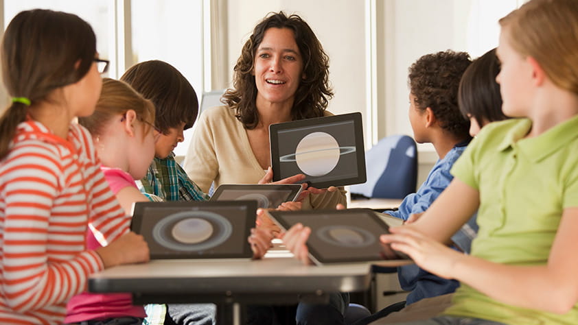 Teacher and students using digital tablets