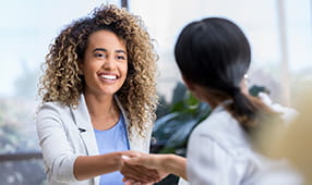 Young professional shaking hands with an interviewer