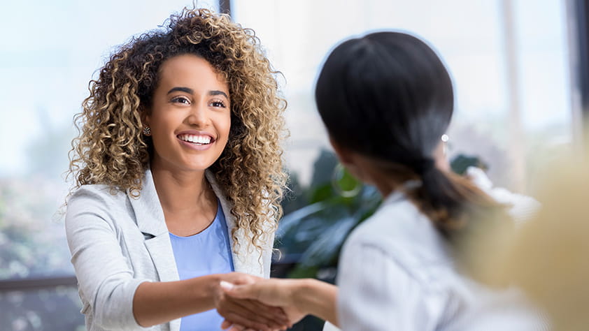 Young professional shaking hands with an interviewer