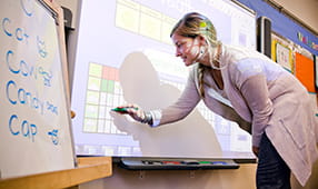 Elementary School Teacher Using Smartboard