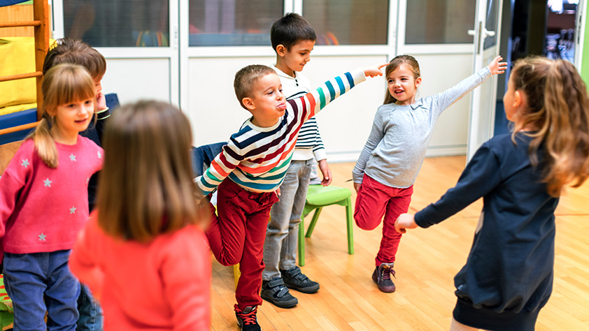 Group of young children exercising in their classroom