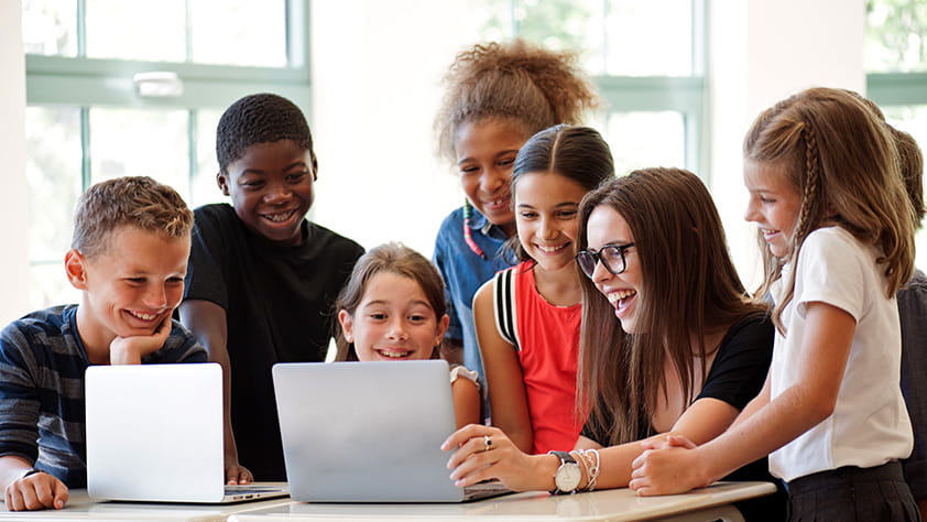 Group of students looking at laptops