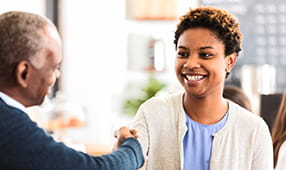 Young woman greets her potential employer before an interview