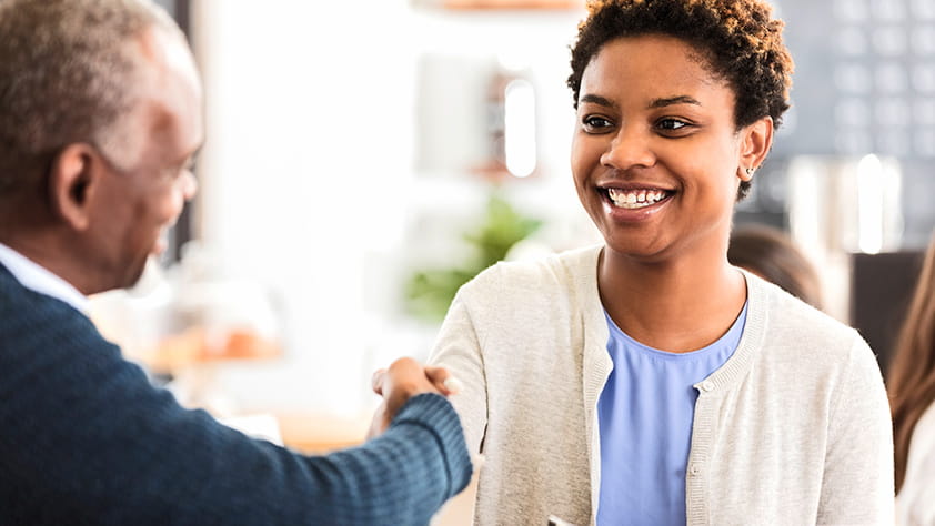 Young woman greets her potential employer before an interview