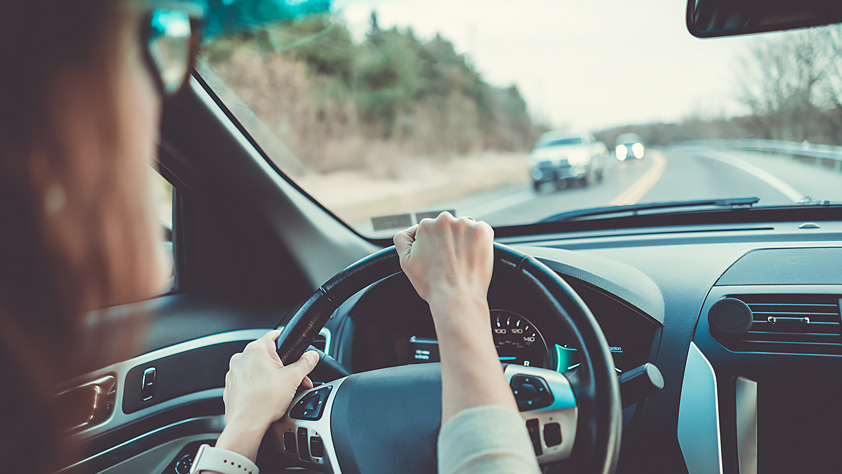 Defensive Driving Tactics to Protect Yourself on the Road - Woman Behind the Wheel of a Car