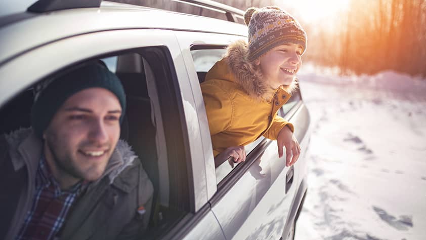 Child Looking Out of Window Station Wagon at Winter Scene