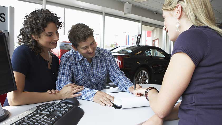 How to Buy a Car Quickly - Couple with Car Saleswoman Signing Paperwork