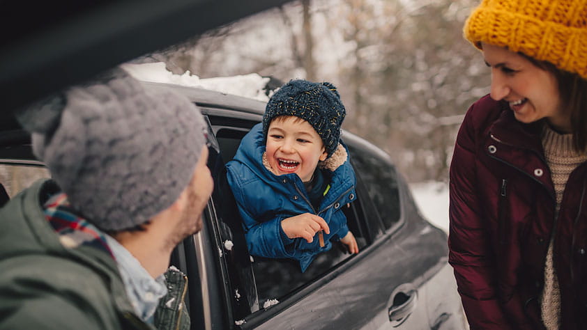 Happy family on a winter road trip