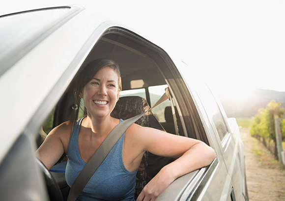 Woman Sitting in Car Smiling