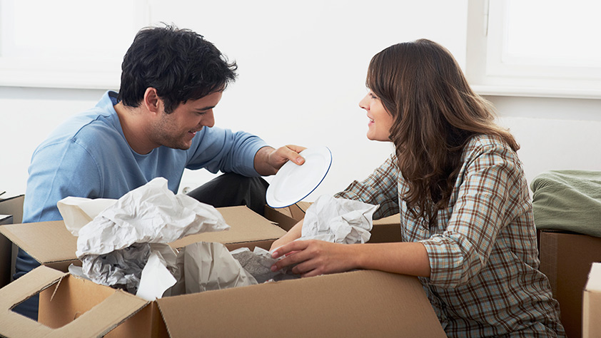 Couple Unpacking Boxes After Move