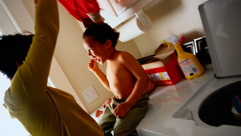 Mom and Son Laughing in Laundry Room