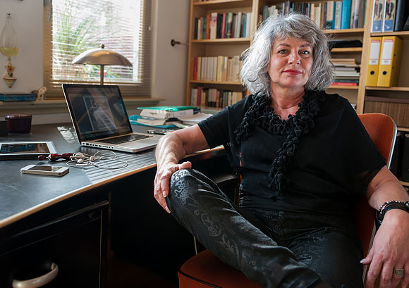 Confident Older Woman Sitting at Her Home Office Desk