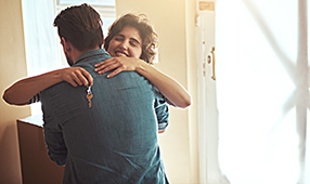 Couple Embracing After New Home Purchase