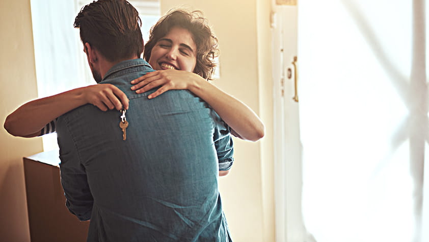 Couple Embracing After New Home Purchase