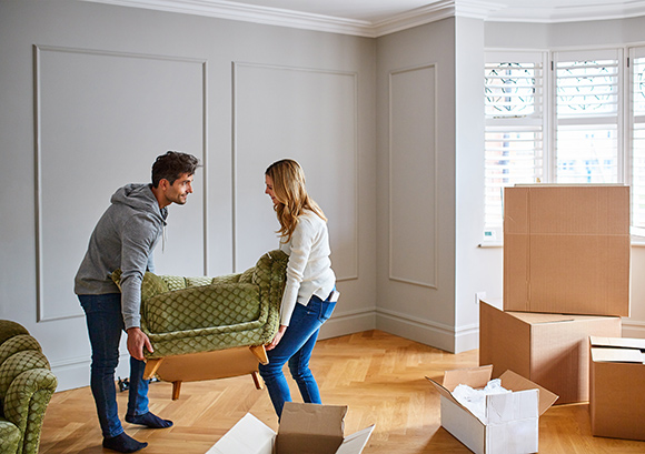 Couple Moving Small Couch in Home