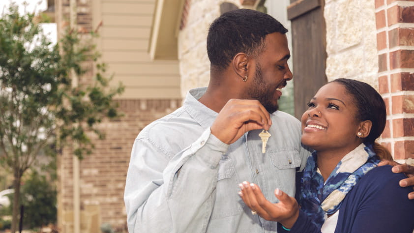 Husband Handing Wife Keys to New Home