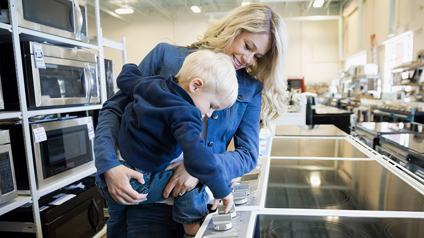 Mom Shopping with Small Child for Kitchen Appliances