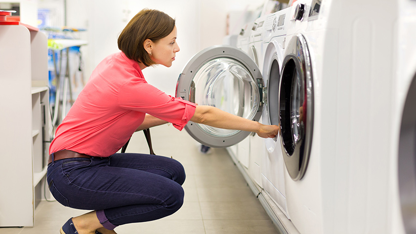 Woman Reviewing Laundry Dryer in Store