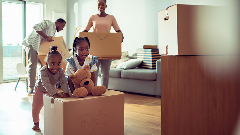 Young Family Unpacking Their Things in Their New Home