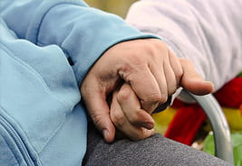 Older couple holding hands