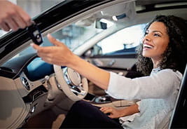 Woman Sitting in Her New Car and Receiving Keys