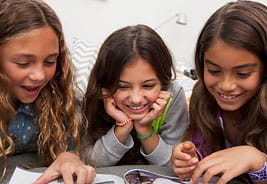 Three Girls Reading a Magazine Together