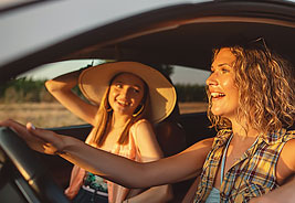 Two Happy Women in a Car - NEA Auto Buying Program