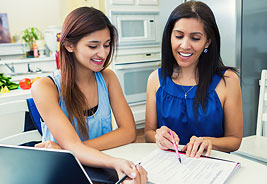 Paying for College - Mother and Teen Daughter Looking at Paperwork