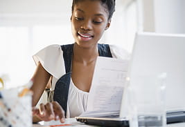 Paying for College - Young Woman Calculating Her Bills on Her Laptop