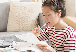 NEA Student Loan Refinance Program - Young Woman Looking at Paperwork