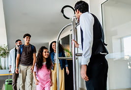 Family Talking  to Bellhop at a Hotel