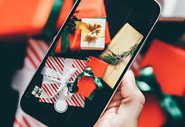 Close Up of Woman Taking Pictures of Holiday Gifts on Phone