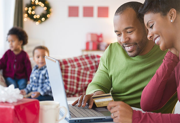 Mother and father shopping online for the holidays