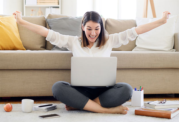 Happy woman celebrating saving money while shopping online at home!