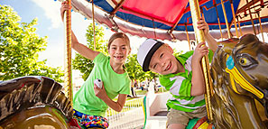 Two Children on Carousel Horses