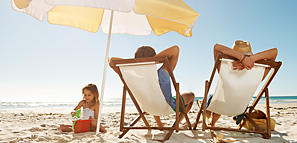 Family Relaxing at the Beach Under a Yellow Umbrella