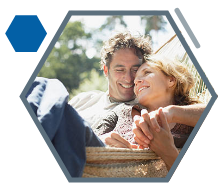 Older couple sitting in a hammock enjoying summer