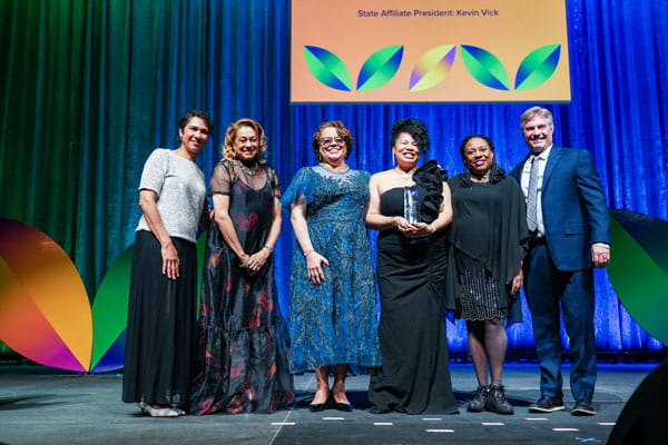 Janet Damon accepts the 2026 NEA Member Benefits Award for Teaching Excellence