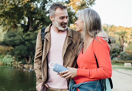 Happy Mature Couple Walking by a River