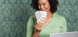 Woman Holding Money and Laptop