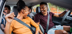 NEA Auto Buying Program - Friends talking in a car during a fun road trip.