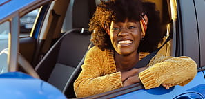 Smiling woman sitting in a car