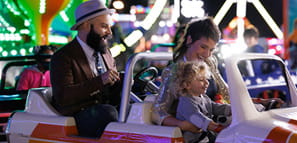 NEA Discount Tickets Program - Family enjoys a mini-truck ride at the carnival