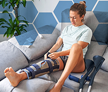 Woman with a Leg Brace Sitting on the Couch 