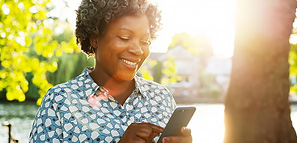 Smiling Woman with Smart Phone Outside