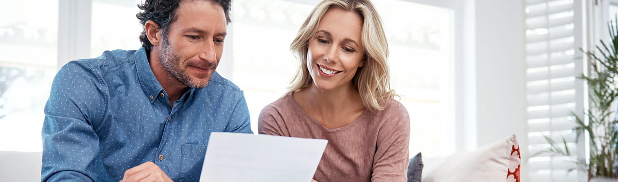 A man and woman exploring how to apply for a personal loan and its benefits.