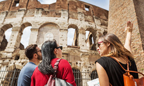 NEA Travel: Guided Tours - Tourists exploring the Coliseum of Rome with their knowledgeable guide.