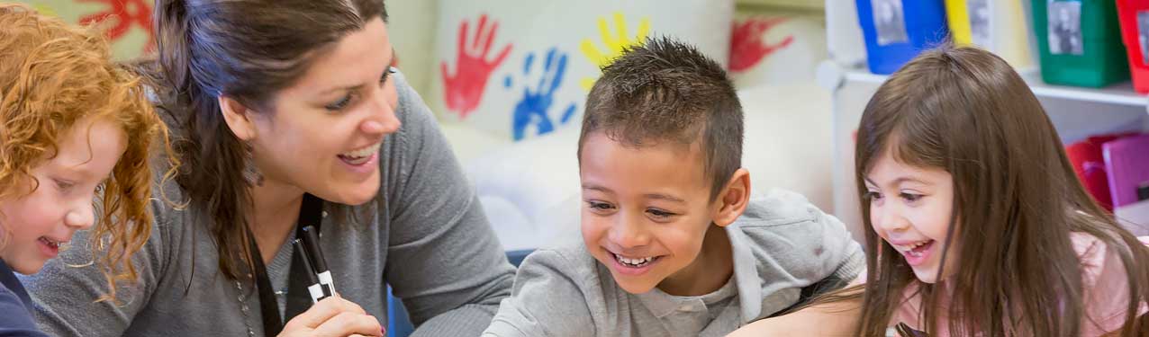 Teacher Helping Students in a Classroom