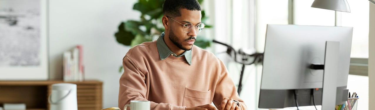 Man Using a Computer At His Home Office