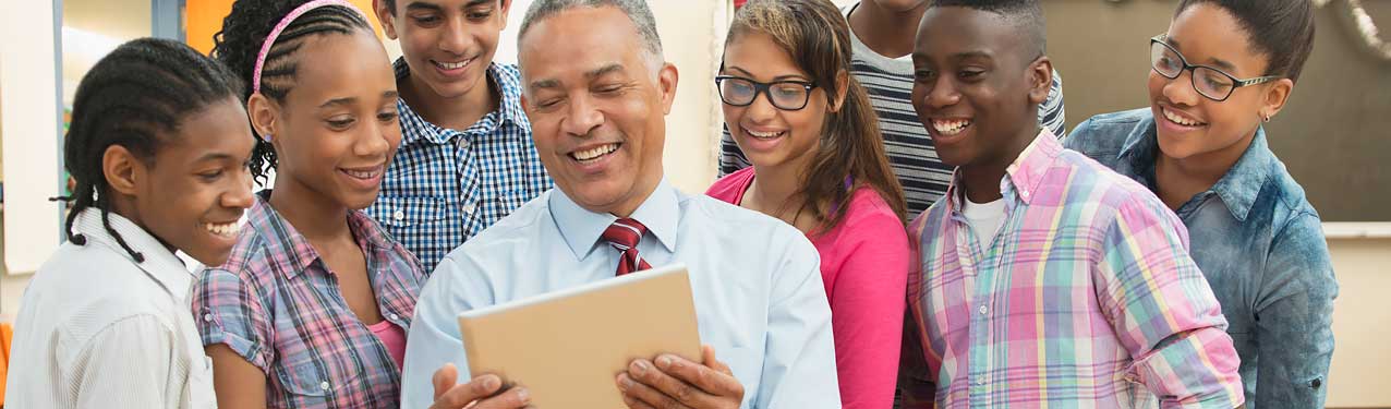 Teacher and Students Using Digital Tablet in Classroom